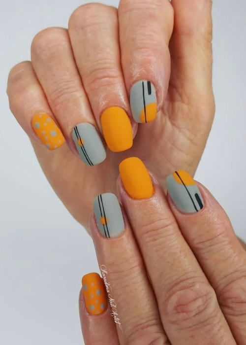 An orange and grey abstract nails design