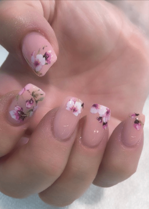 a spring nail design with flowers as a french tip