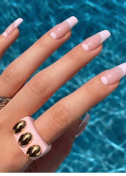 a pink half moon nail design