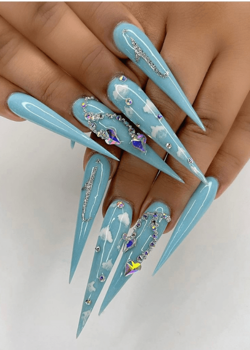 Long acrylic nails with a light blue sky design