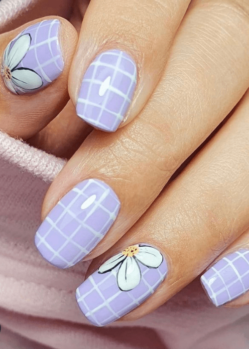 A purple grid with white flowers nail design