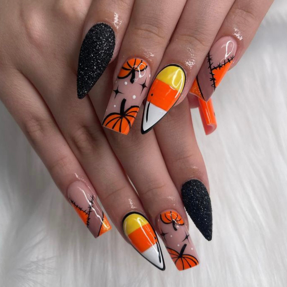 Halloween nail design with a pumpkin design, candy corn design, and patch design