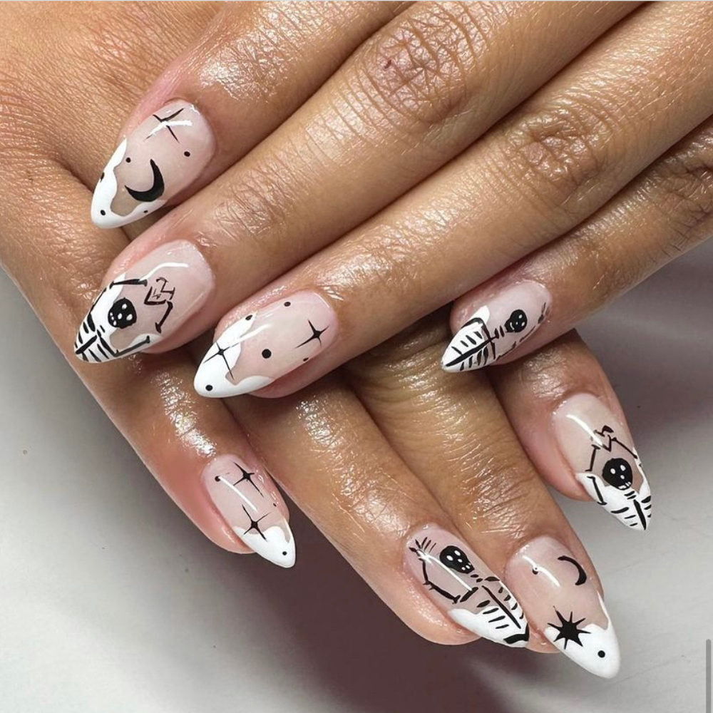 Halloween nail designs: Short almond shaped nails with skeleton designs and stars