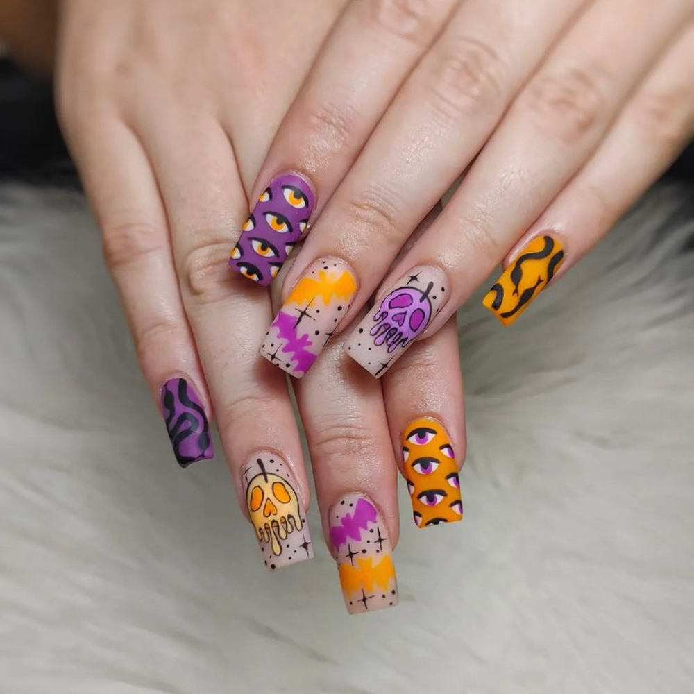 Halloween nail designs: A medium length purple and orange nail design