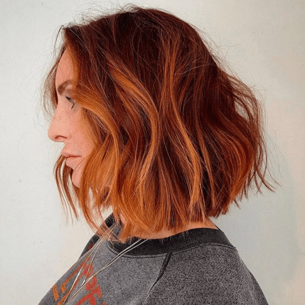 A medium length cut on auburn hair