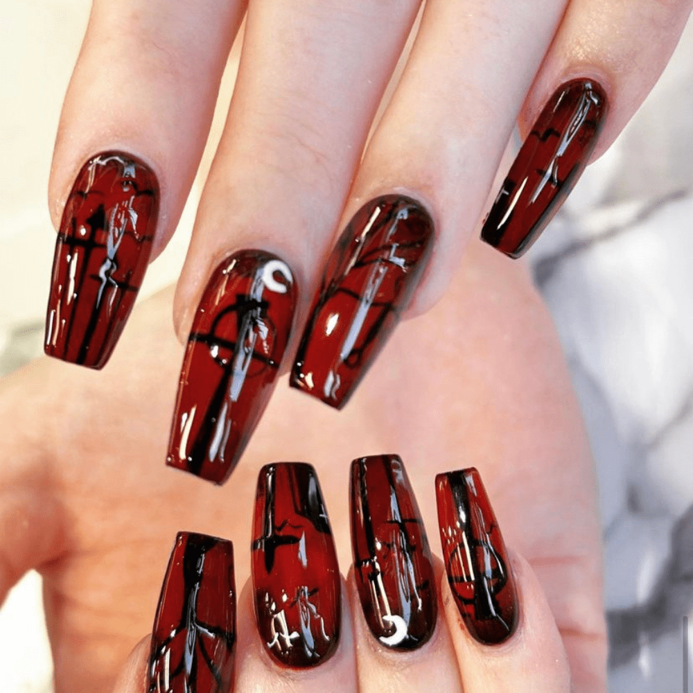 Red and black nail design with crosses