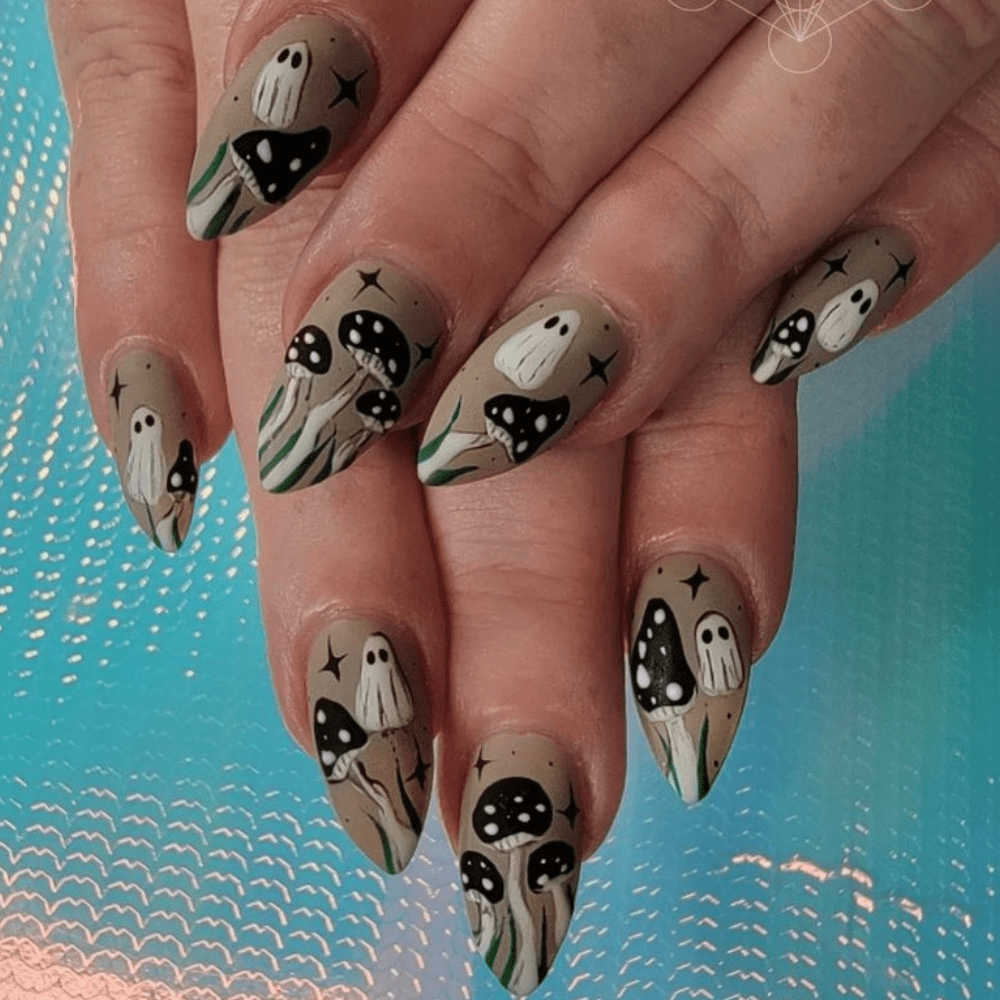 A ghost nail design with mushrooms and stars