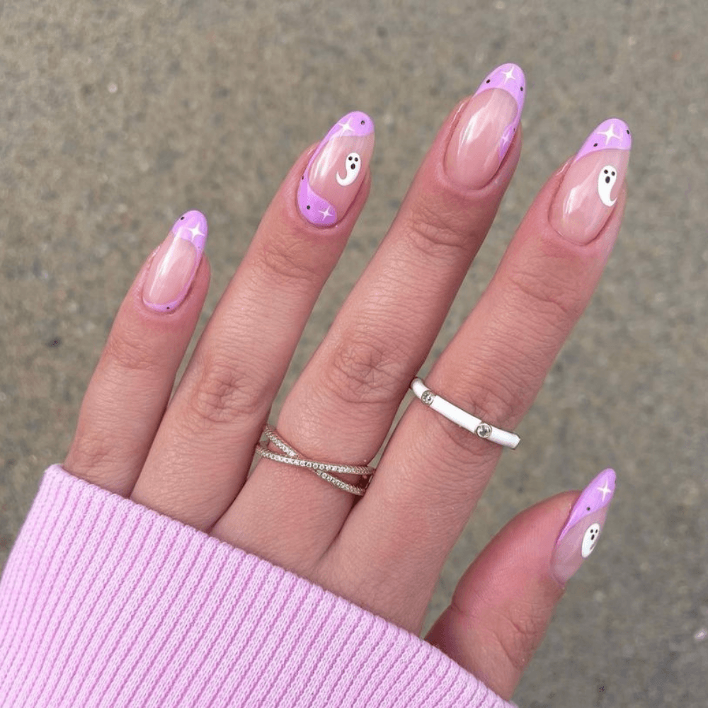 A purple-pink nail design with ghosts and stars