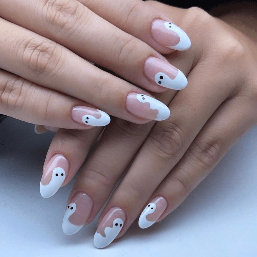 A ghost nail design with ghosts on the tips of the nails