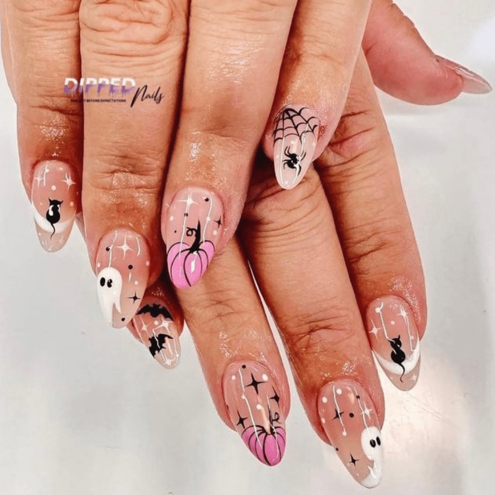 A Halloween nail design with a black cat, ghosts, pink pumpkins, and spiders