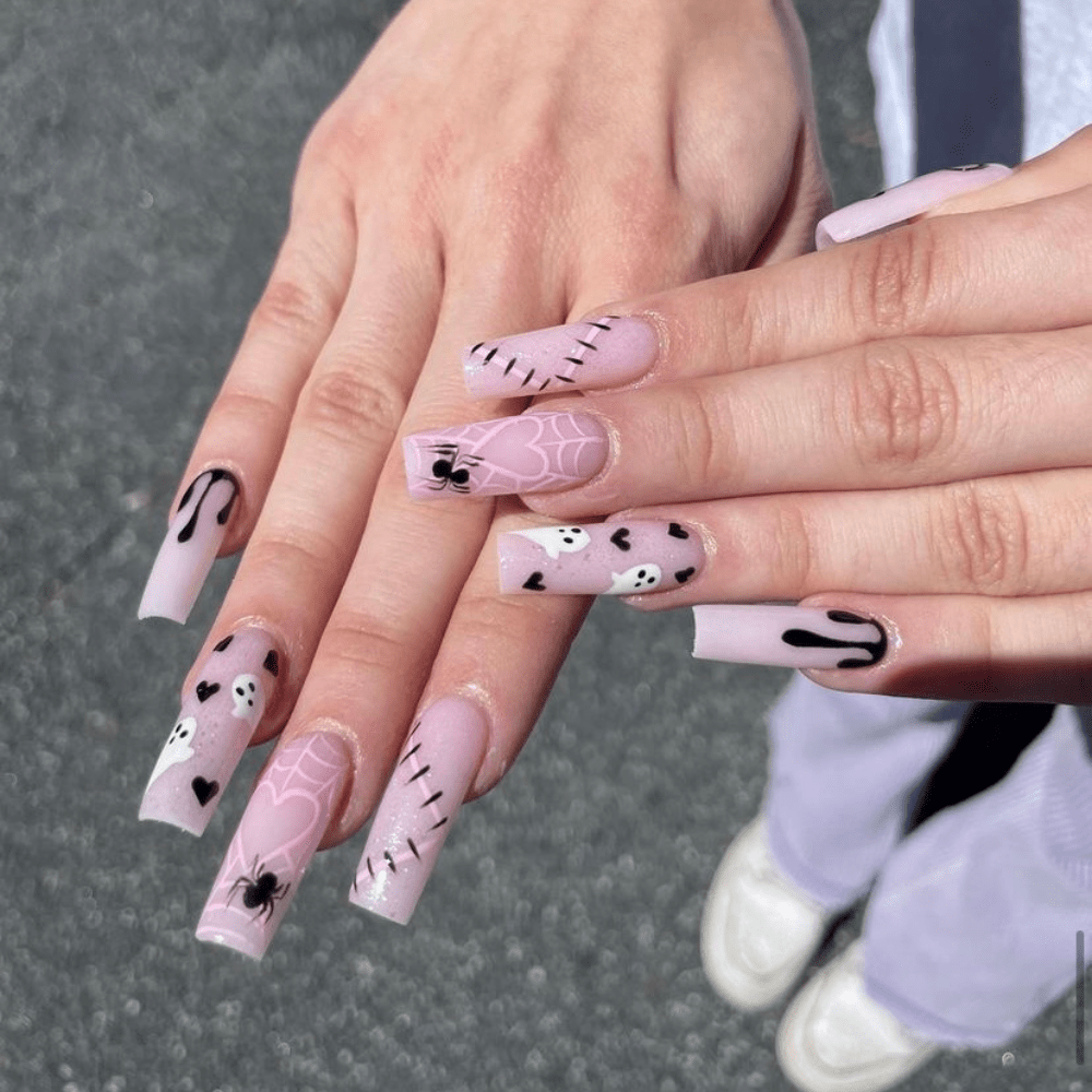 A pink and black Halloween nail design on long square nails